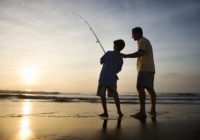 Boy and father fishing